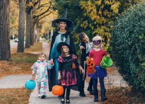 Trick Or Treat. Mother With Children Going To Trick Or Treat On Halloween Holiday.